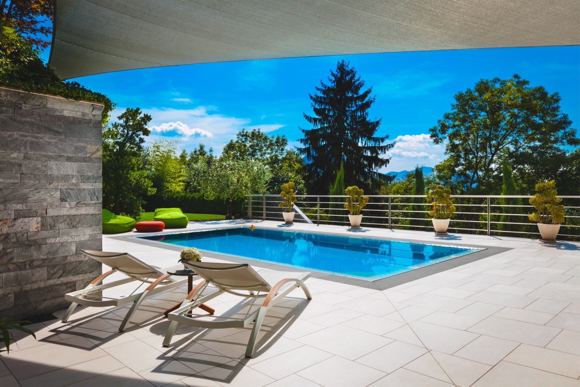 Rectangular pool with lounge chairs on a concrete deck