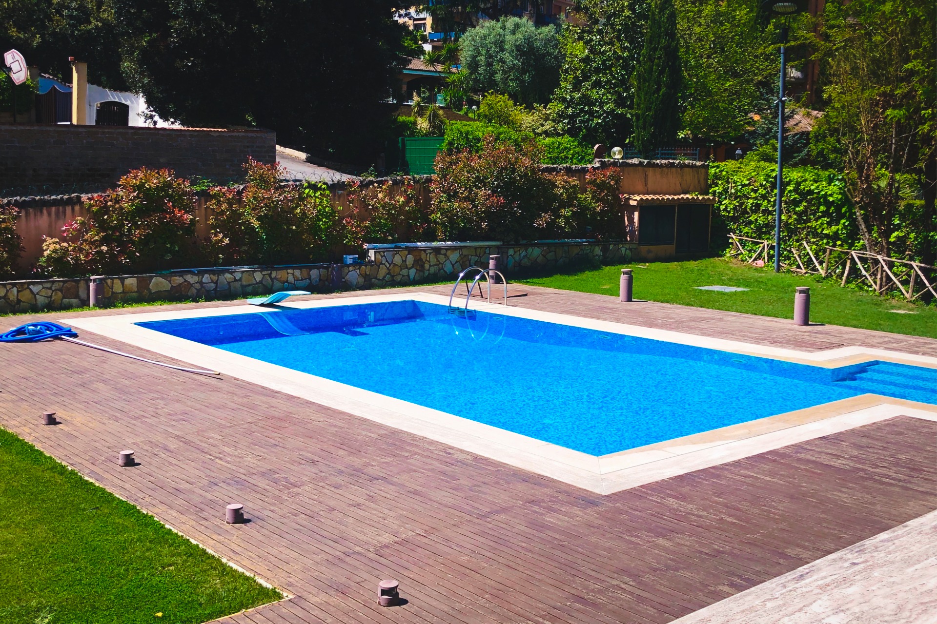 Inground pool with a stone waterfall and a diving board